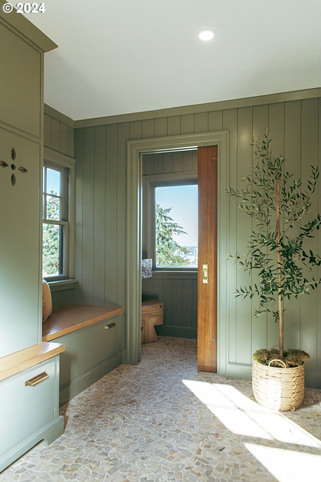 mudroom with wood walls