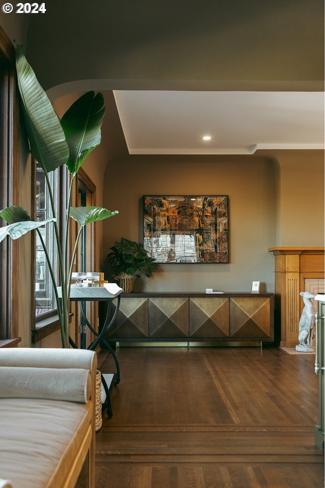 corridor with hardwood / wood-style flooring and ornamental molding