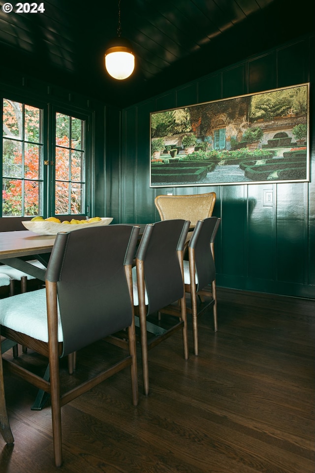 dining room featuring hardwood / wood-style floors and wood ceiling