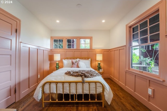 bedroom with dark hardwood / wood-style flooring