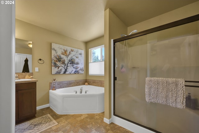 bathroom with vanity and shower with separate bathtub