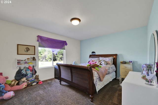 bedroom featuring dark carpet