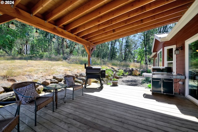 wooden deck featuring a grill