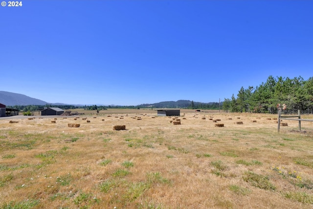 view of yard with a mountain view and a rural view