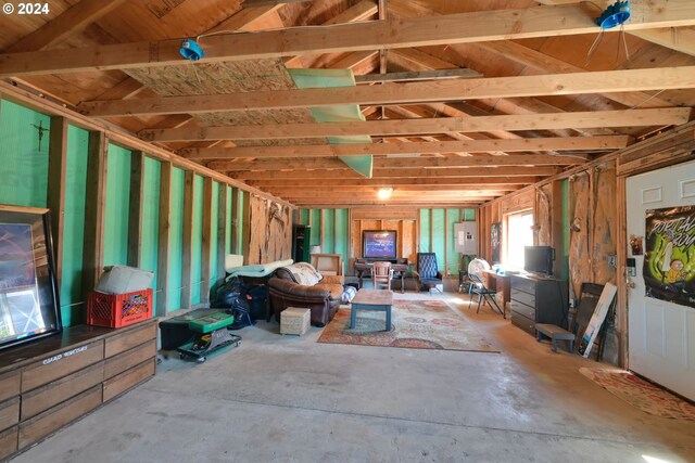 miscellaneous room with electric panel and concrete floors