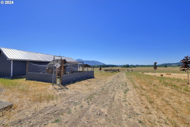 view of yard featuring a mountain view and a rural view