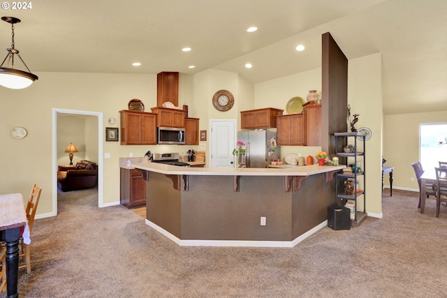 kitchen featuring a kitchen bar, light colored carpet, decorative light fixtures, and appliances with stainless steel finishes