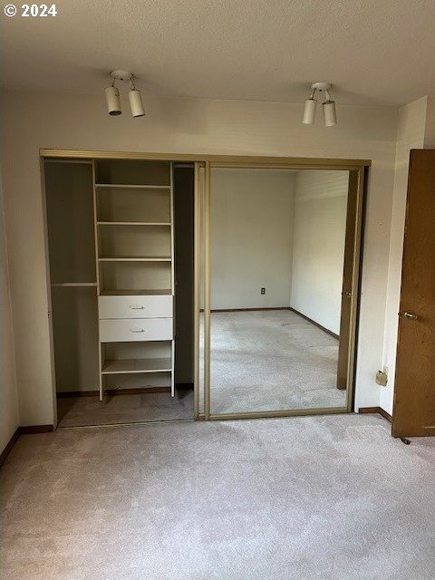 interior space featuring carpet and a textured ceiling