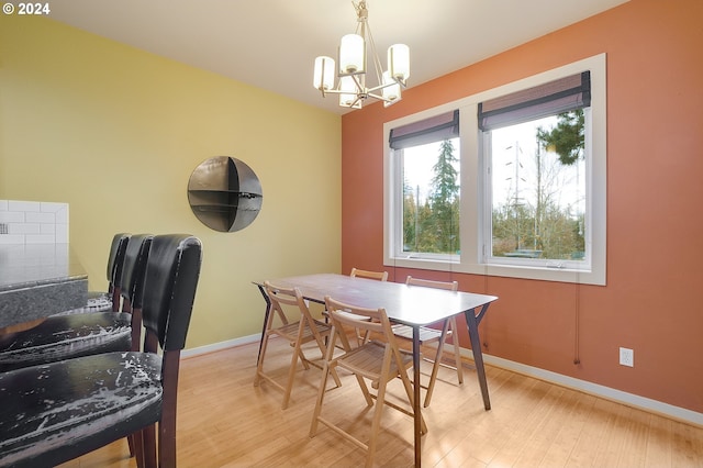 dining space with an inviting chandelier and light wood-type flooring