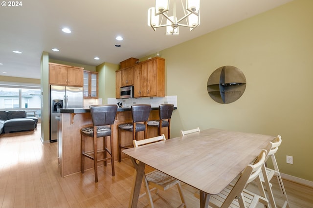 dining area featuring a chandelier and light hardwood / wood-style flooring