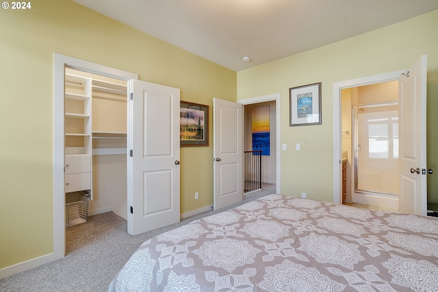 bedroom with a walk in closet, light carpet, and a closet