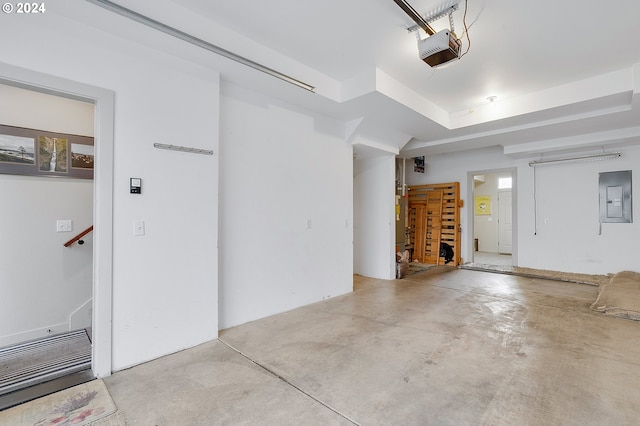 garage featuring electric panel and a garage door opener