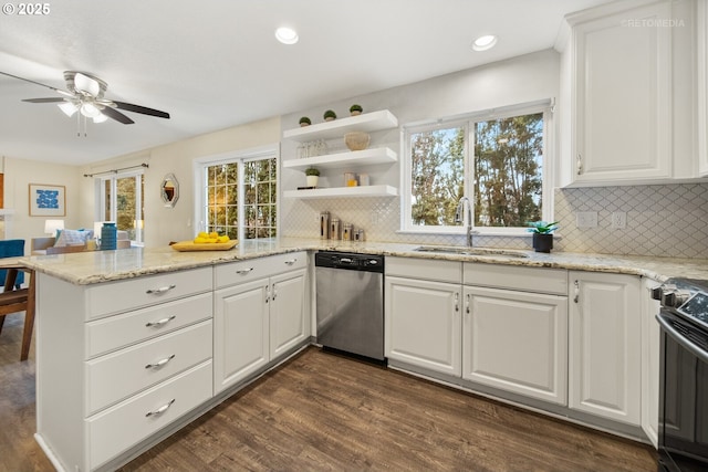 kitchen with sink, dark wood-type flooring, stainless steel appliances, white cabinets, and kitchen peninsula