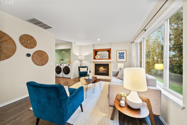 living room featuring hardwood / wood-style flooring and washing machine and clothes dryer