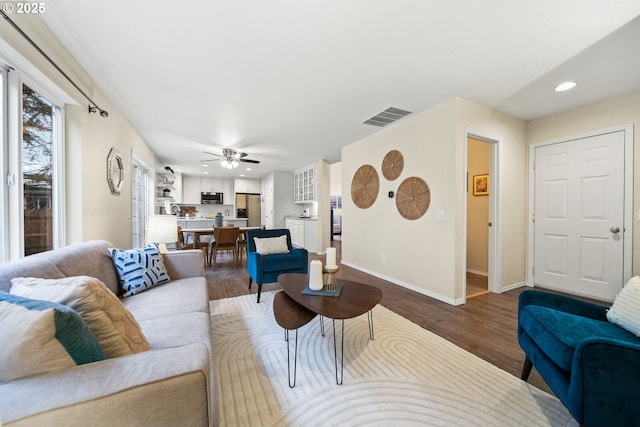 living room featuring ceiling fan and hardwood / wood-style floors