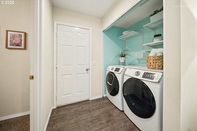 washroom featuring dark hardwood / wood-style floors and washer and dryer