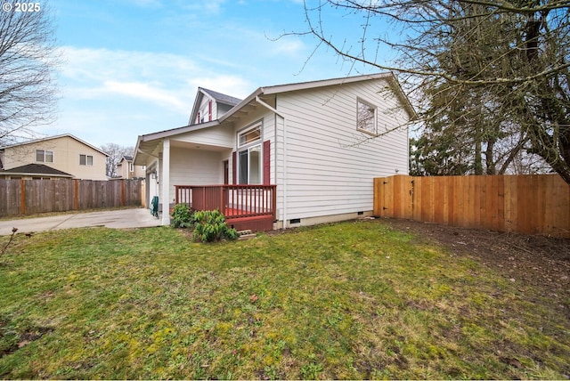 view of property exterior featuring a patio and a lawn