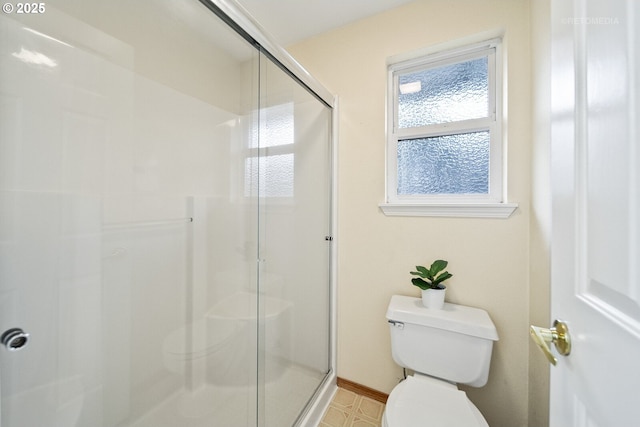 bathroom featuring toilet and an enclosed shower