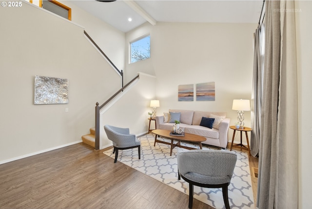 living room with wood-type flooring, beam ceiling, and high vaulted ceiling