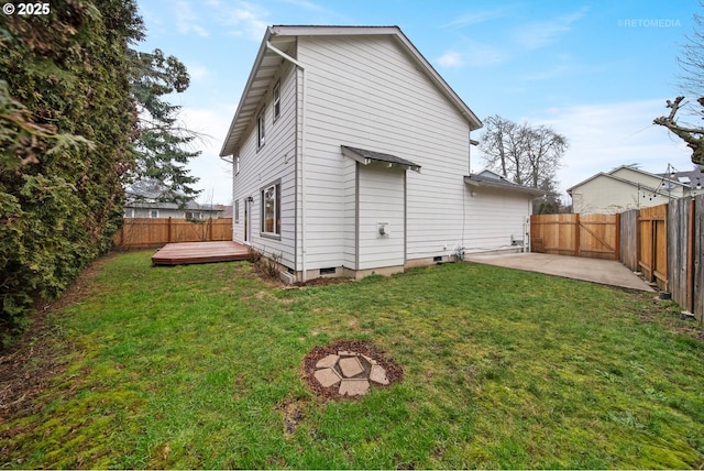 back of property featuring a yard, a deck, and a patio