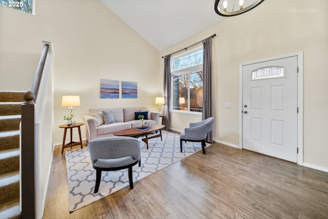 entryway featuring hardwood / wood-style floors and high vaulted ceiling