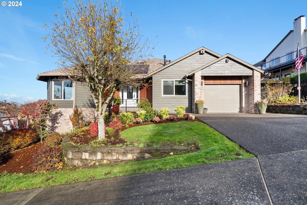 view of front of property with a garage and a front yard