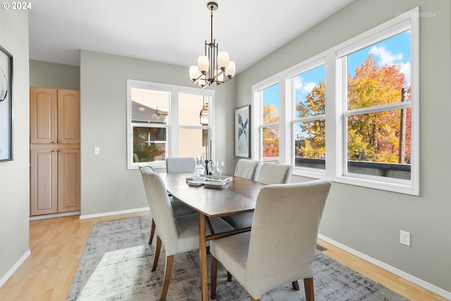 dining area featuring light hardwood / wood-style flooring and a chandelier