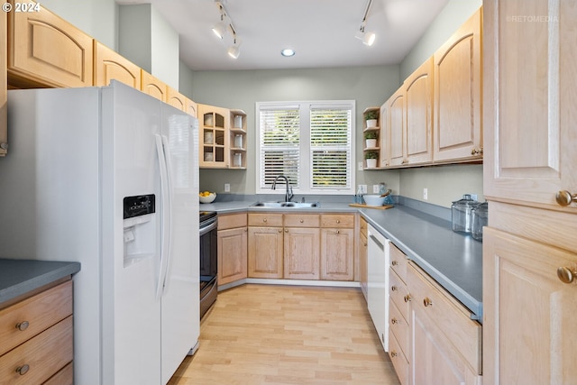 kitchen with light brown cabinets, sink, and white appliances