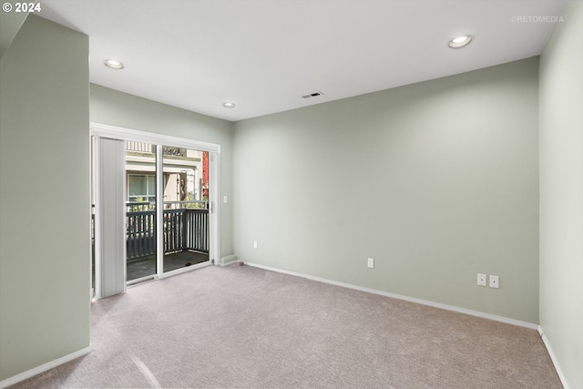 unfurnished room featuring light colored carpet