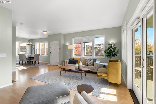 living room with light hardwood / wood-style floors and a chandelier