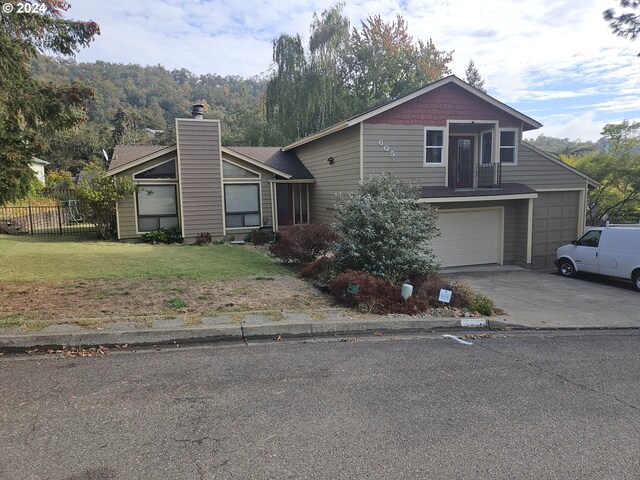 view of front facade with a front lawn and a garage