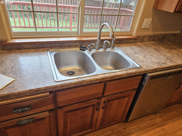 kitchen with hardwood / wood-style floors, sink, and dishwasher