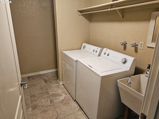 washroom featuring washing machine and dryer and sink