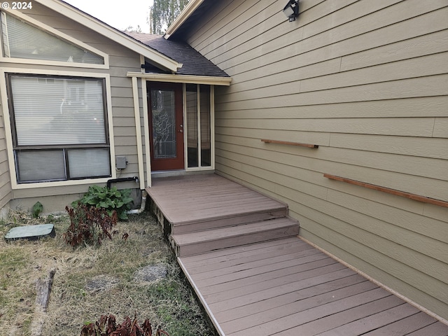 view of exterior entry with a deck