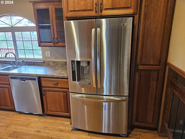 kitchen featuring sink, stainless steel appliances, and light hardwood / wood-style flooring