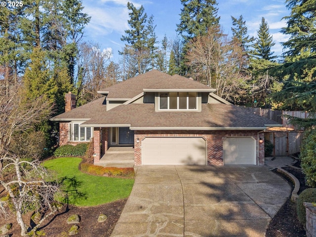 view of front of home with a front yard and a garage