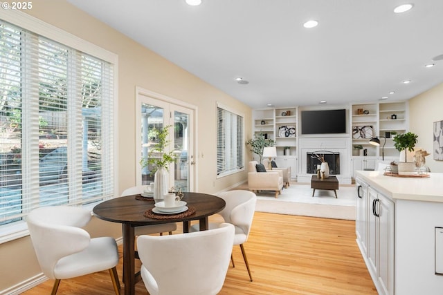 dining area featuring light hardwood / wood-style floors and built in features