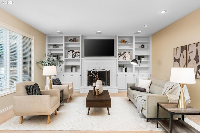 living room featuring a fireplace and plenty of natural light