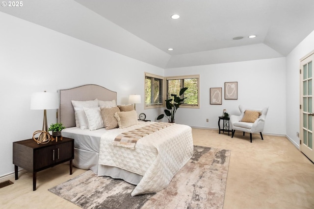 carpeted bedroom with lofted ceiling