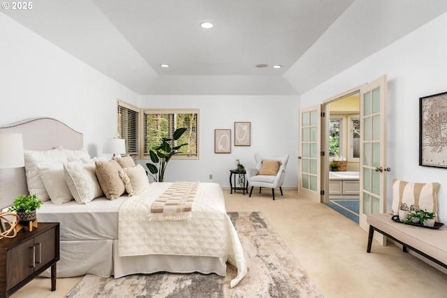 carpeted bedroom with lofted ceiling and french doors