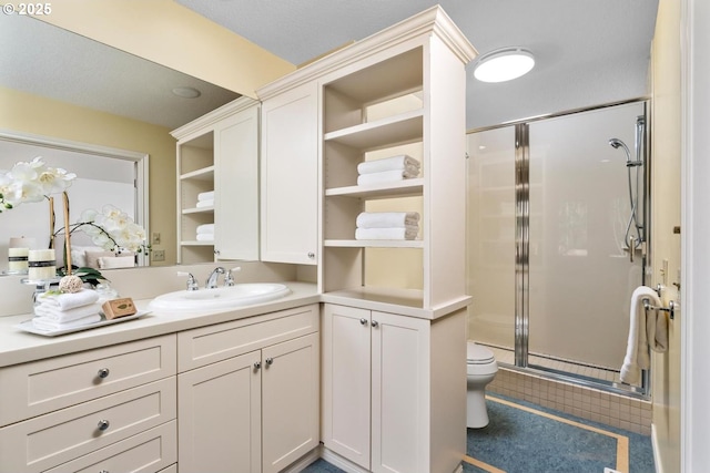 bathroom featuring vanity, an enclosed shower, and toilet