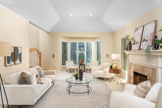 living room featuring carpet flooring, a high end fireplace, and lofted ceiling