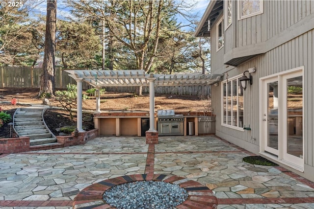 view of patio / terrace featuring area for grilling, a pergola, and an outdoor kitchen