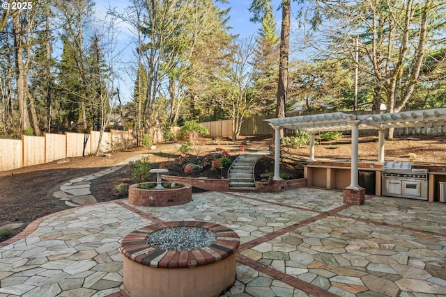 view of patio with exterior kitchen and a pergola