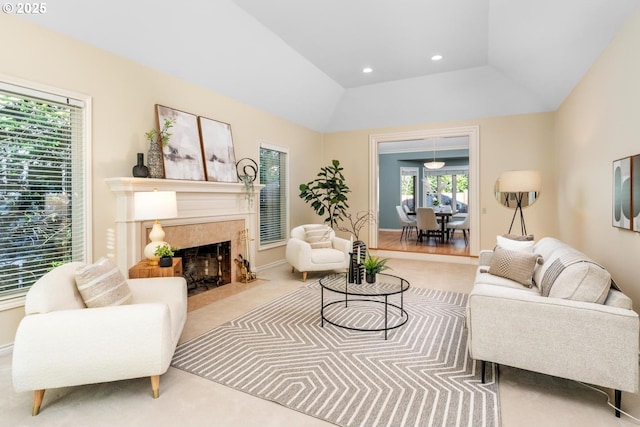 living room featuring a tray ceiling, a fireplace, and lofted ceiling