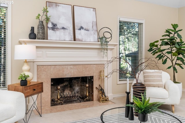 living area with a tile fireplace