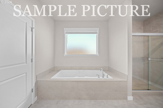 bathroom featuring tile floors and plus walk in shower