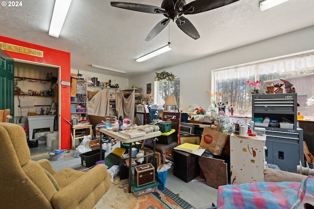 misc room featuring ceiling fan, concrete flooring, and a textured ceiling