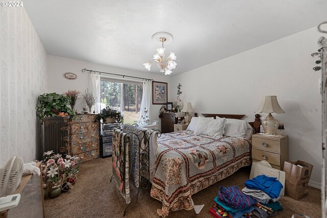 bedroom with an inviting chandelier and carpet