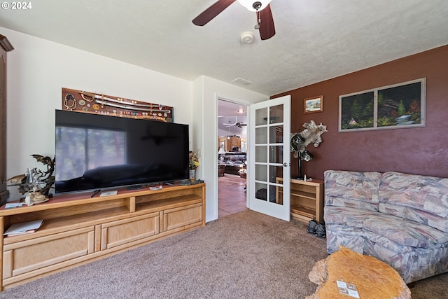 living room with carpet flooring, a textured ceiling, ceiling fan, and french doors